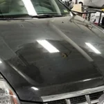 hood of black car in detailing shop