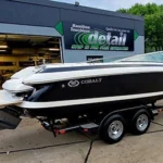 boat on a trailer in front of detail shop