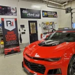 red sports car in detail shop garage, shiny after detailing service