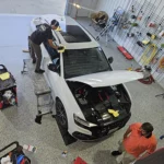 arial shot of car being detailed in shop